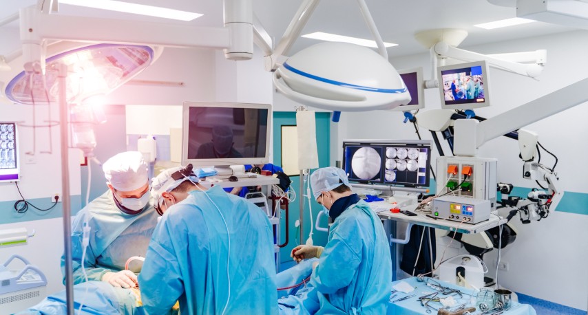 Spinal surgery. Group of surgeons in operating room with surgery equipment. Laminectomy. Modern medical background